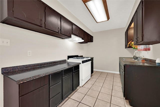 kitchen with white range with gas cooktop, sink, dark brown cabinets, and light tile patterned floors