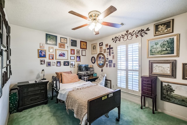 carpeted bedroom with ceiling fan and a textured ceiling