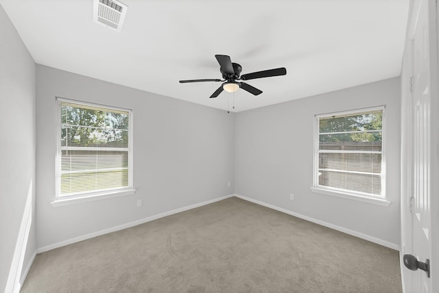 carpeted spare room with ceiling fan