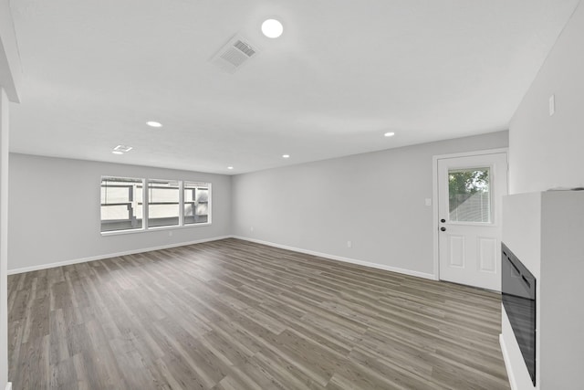 unfurnished living room with hardwood / wood-style flooring and plenty of natural light