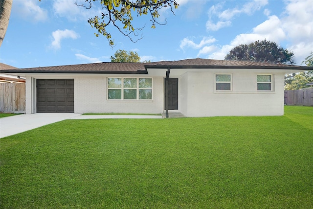 ranch-style home with a garage and a front yard