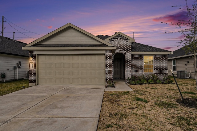 single story home with central AC unit, a garage, and a lawn