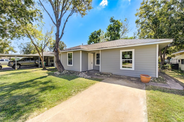 view of front facade featuring a front yard and a carport