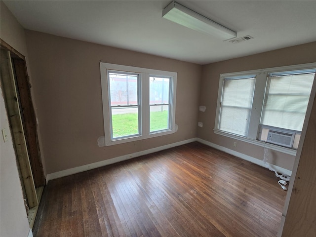 empty room with cooling unit and dark wood-type flooring