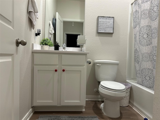 full bathroom with vanity, hardwood / wood-style flooring, toilet, and shower / bath combo with shower curtain