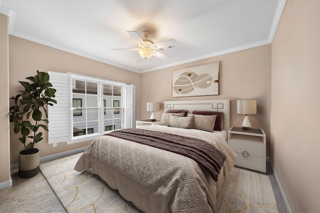 carpeted bedroom featuring ceiling fan and crown molding