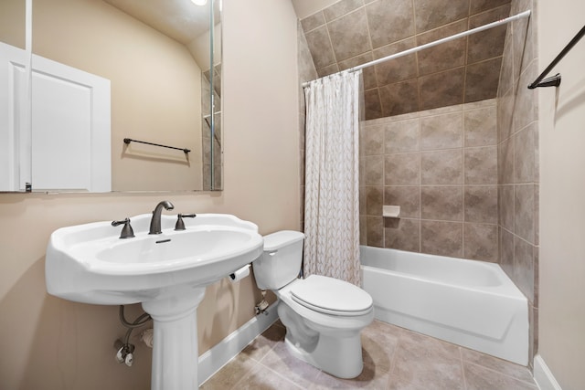 bathroom with tile patterned floors, shower / bath combo, and toilet