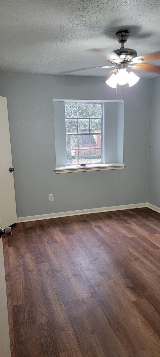 spare room featuring a textured ceiling, dark hardwood / wood-style flooring, and ceiling fan