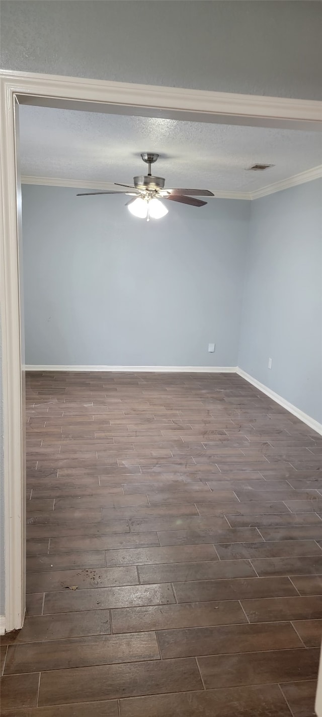 empty room with dark hardwood / wood-style flooring, ceiling fan, and ornamental molding