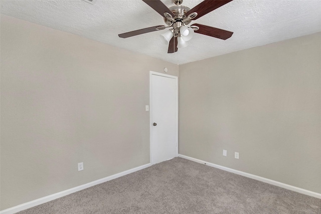 empty room featuring ceiling fan, carpet, and a textured ceiling