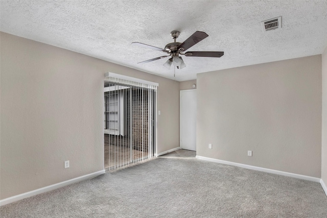 empty room with carpet, a textured ceiling, and ceiling fan