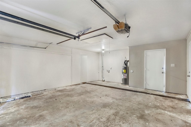 garage featuring a garage door opener and water heater