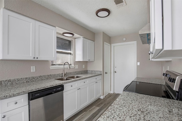 kitchen featuring white cabinetry, dishwasher, sink, electric range oven, and light wood-type flooring