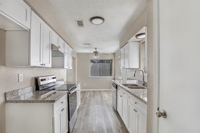 kitchen with white cabinets, stainless steel appliances, light hardwood / wood-style flooring, and sink