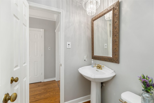 bathroom featuring sink, wood-type flooring, and toilet