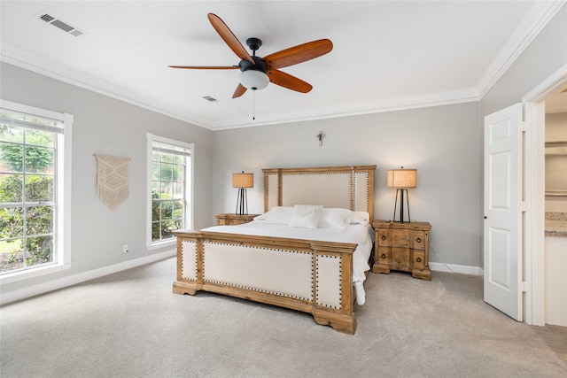 carpeted bedroom with ceiling fan and ornamental molding