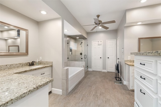 bathroom featuring wood-type flooring, vanity, shower with separate bathtub, and ceiling fan