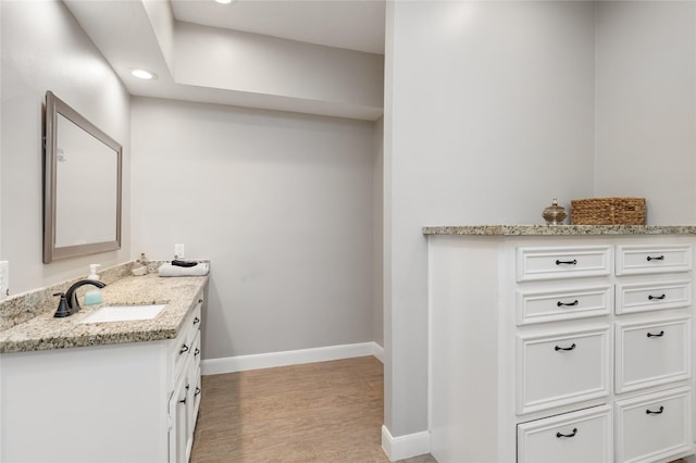 bathroom featuring vanity and hardwood / wood-style flooring