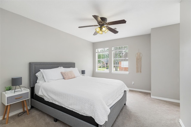 bedroom featuring light carpet and ceiling fan