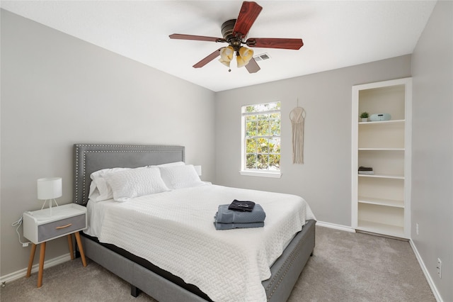 bedroom with ceiling fan and light carpet