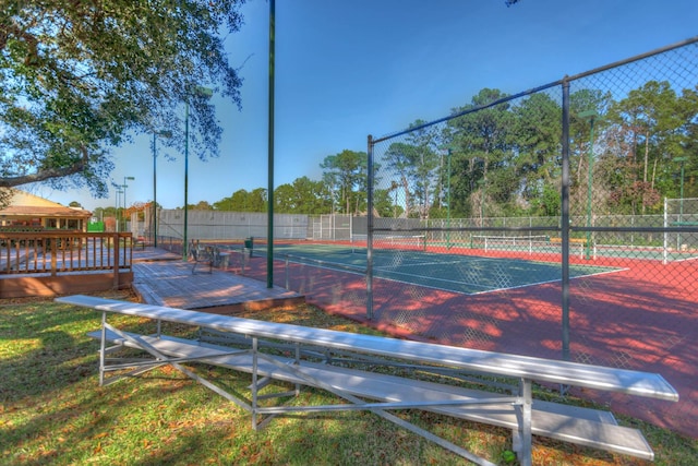 view of sport court with a wooden deck