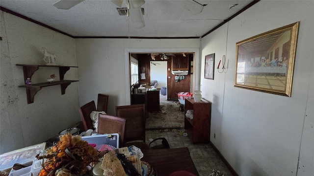 interior space featuring ceiling fan and ornamental molding