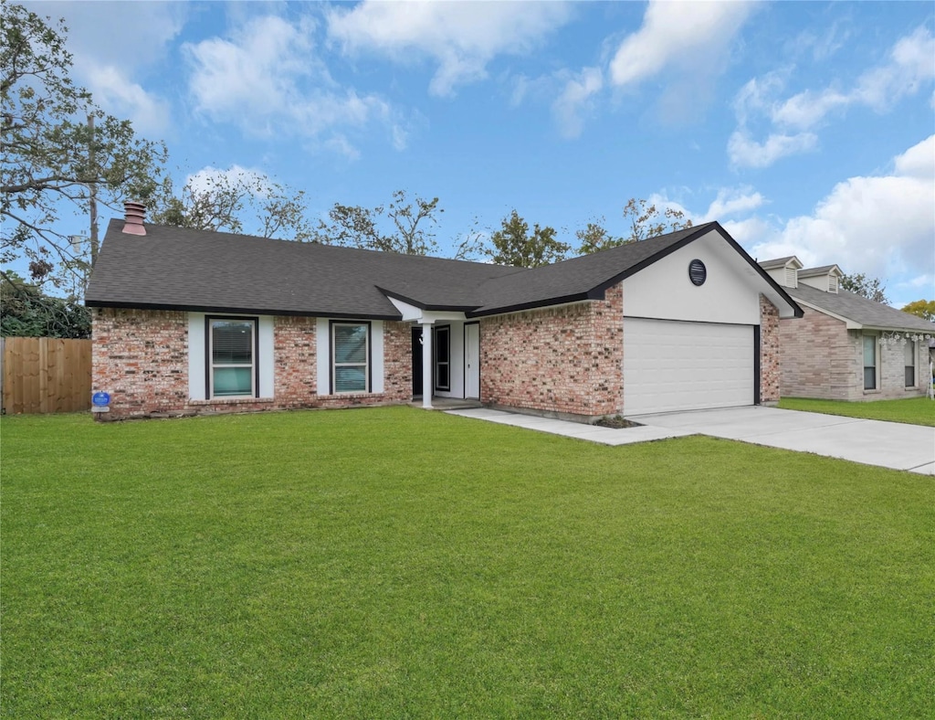 ranch-style house featuring a garage and a front lawn