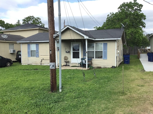 view of front of house with a front lawn and cooling unit