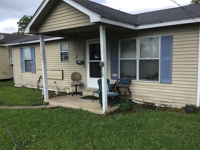 view of front facade with a front lawn and a patio area