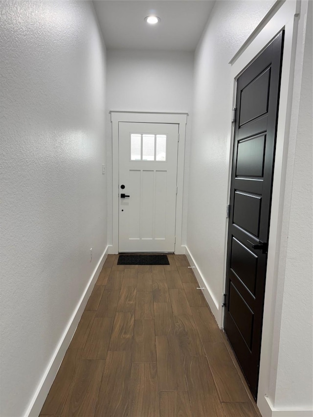 entryway with dark hardwood / wood-style flooring