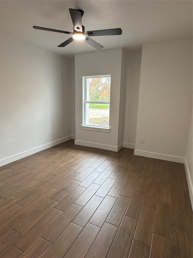 empty room with ceiling fan and hardwood / wood-style flooring