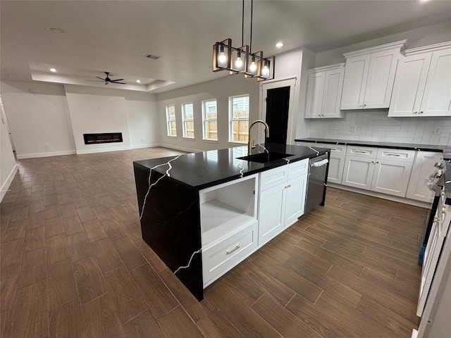 kitchen with white cabinetry, a kitchen island with sink, and dishwasher