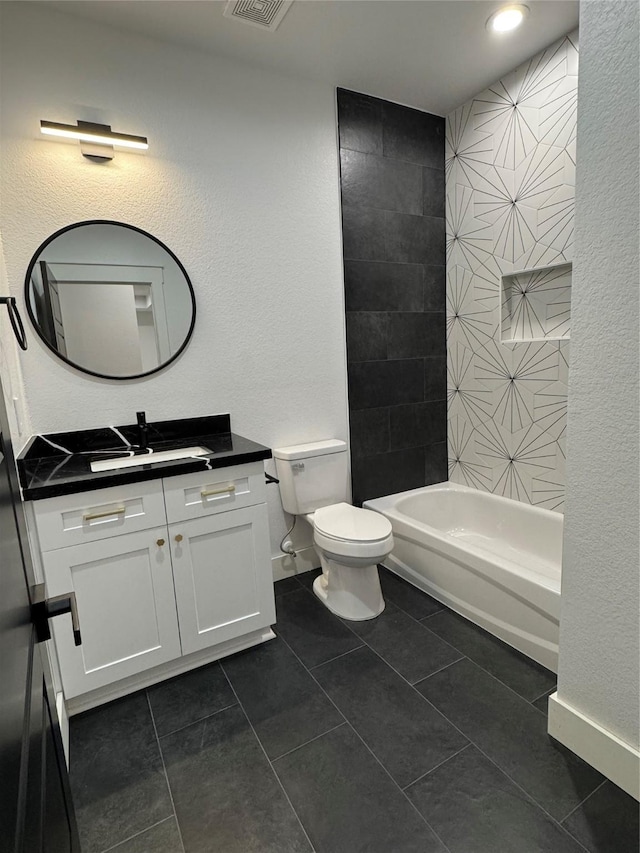 full bathroom with tile patterned floors, vanity, tiled shower / bath combo, and toilet