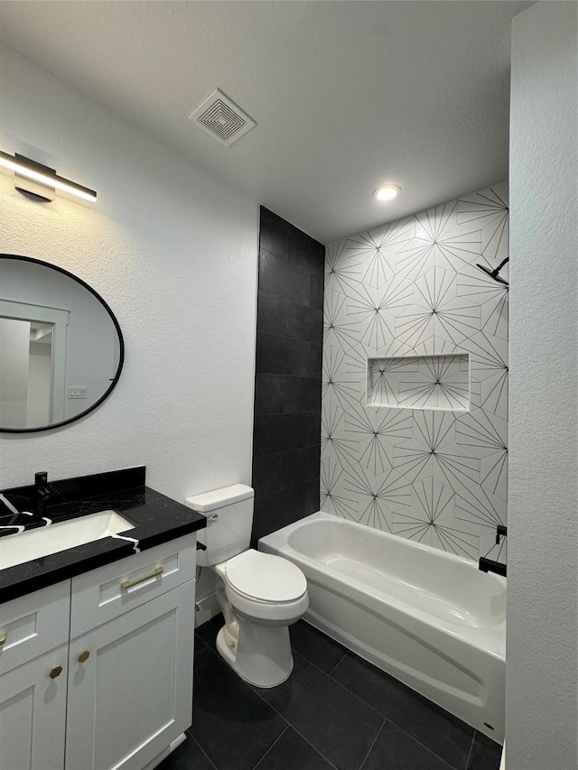 full bathroom with toilet, vanity, tile patterned floors, and tiled shower / bath