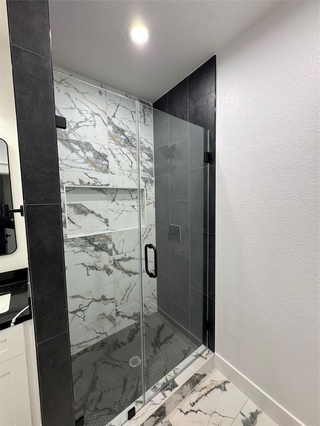 bathroom featuring vanity and an enclosed shower