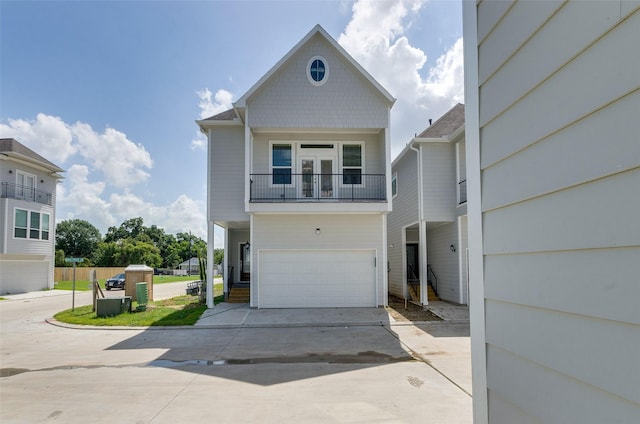 view of front property featuring a garage and a balcony