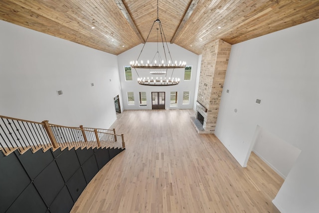 interior space featuring wooden ceiling, high vaulted ceiling, an inviting chandelier, hardwood / wood-style flooring, and beamed ceiling