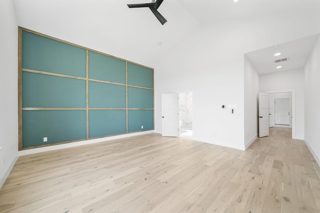 spare room with ceiling fan, light wood-type flooring, and high vaulted ceiling