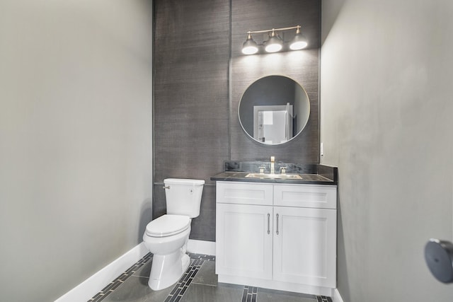 bathroom featuring tile patterned flooring, vanity, and toilet