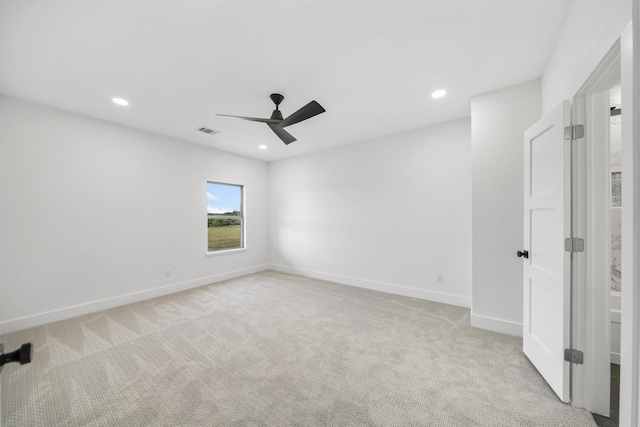 carpeted spare room featuring ceiling fan