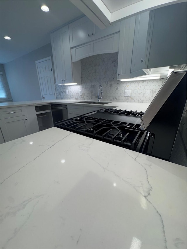 kitchen featuring dishwasher, sink, white cabinets, decorative backsplash, and light stone countertops