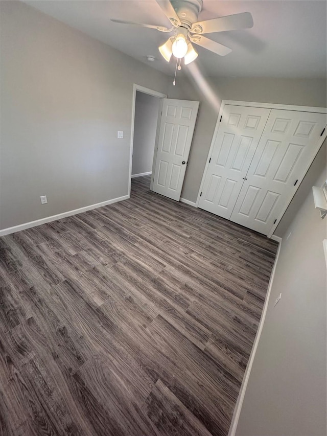 unfurnished bedroom featuring ceiling fan, dark hardwood / wood-style floors, and a closet