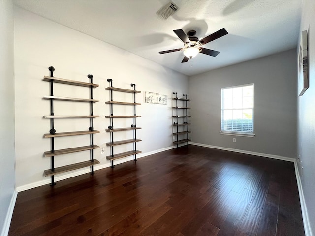 empty room featuring ceiling fan and dark hardwood / wood-style flooring