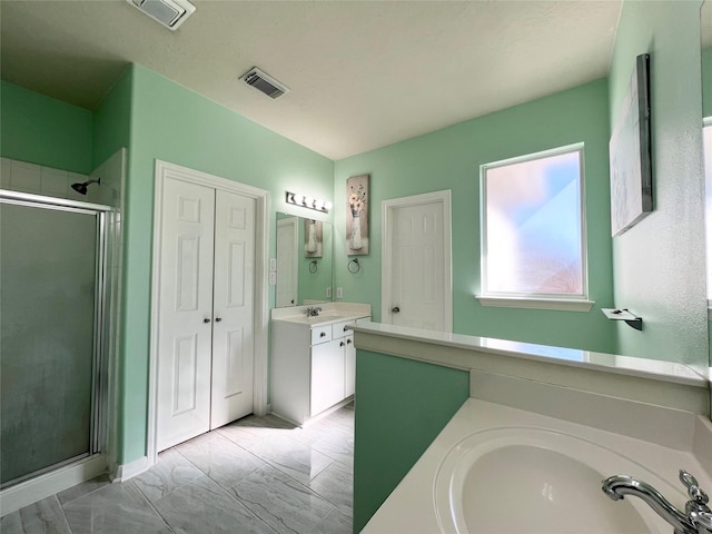 bathroom featuring vanity and a shower with shower door