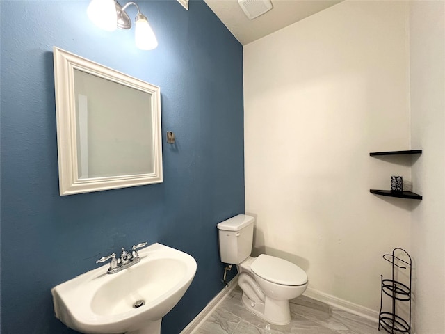 bathroom with toilet and sink