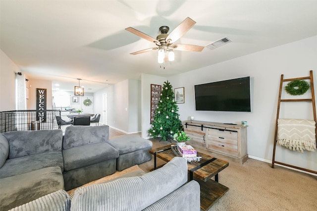 carpeted living room featuring ceiling fan