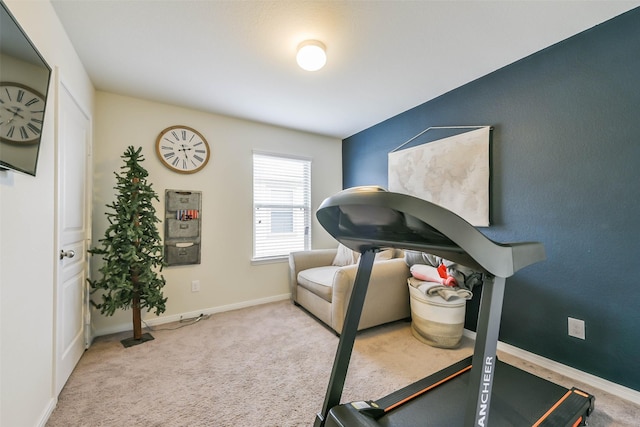 exercise room with light colored carpet