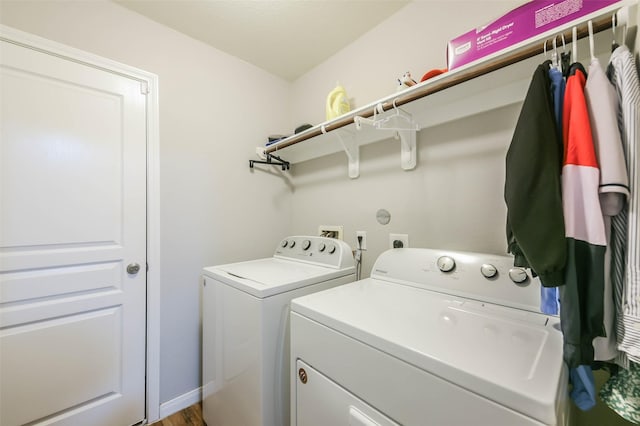 clothes washing area featuring washing machine and dryer and hardwood / wood-style floors