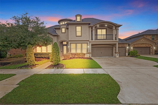 view of front of property featuring a lawn and a balcony