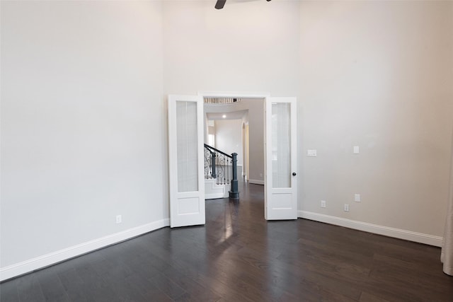 unfurnished room with french doors, dark hardwood / wood-style flooring, and ceiling fan